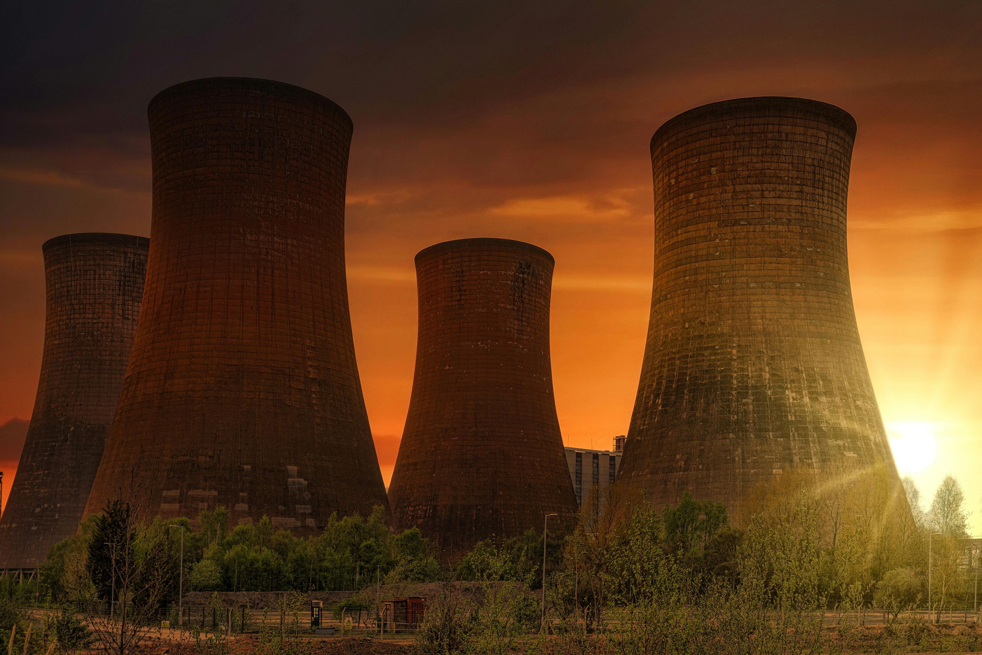 Wide shot of a nuclear power plant wityh four cooling towers