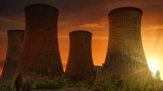 Wide shot of a nuclear power plant wityh four cooling towers
