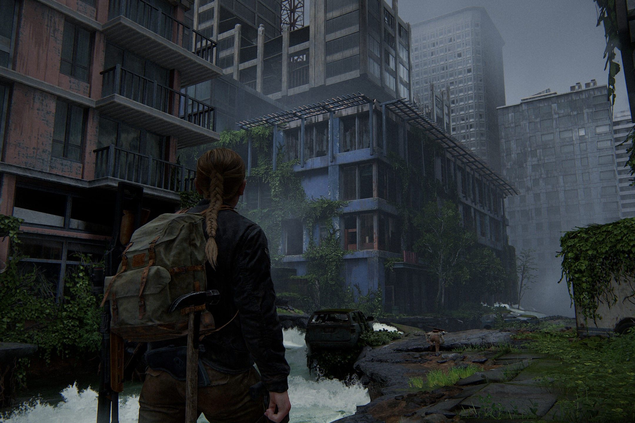 Screenshot from The Last of Us Part II showing Abby walking through the city