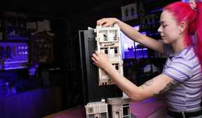 An image showing a person putting together some cardboard pieces on a PC case