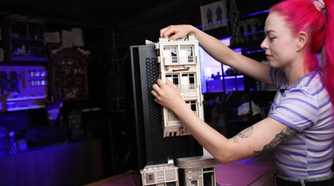 An image showing a person putting together some cardboard pieces on a PC case