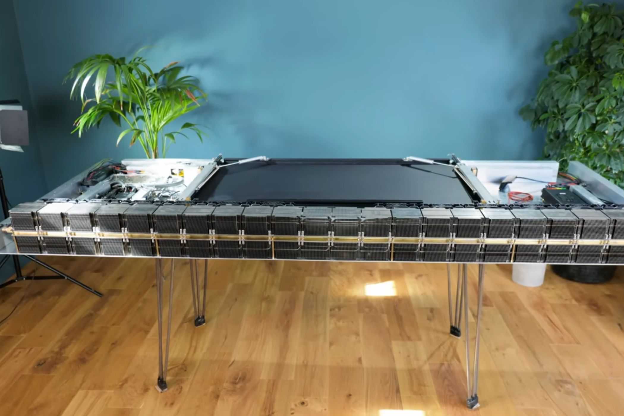 An image showing a table flipped upside with a PC built underneat it