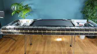 An image showing a table flipped upside with a PC built underneat it