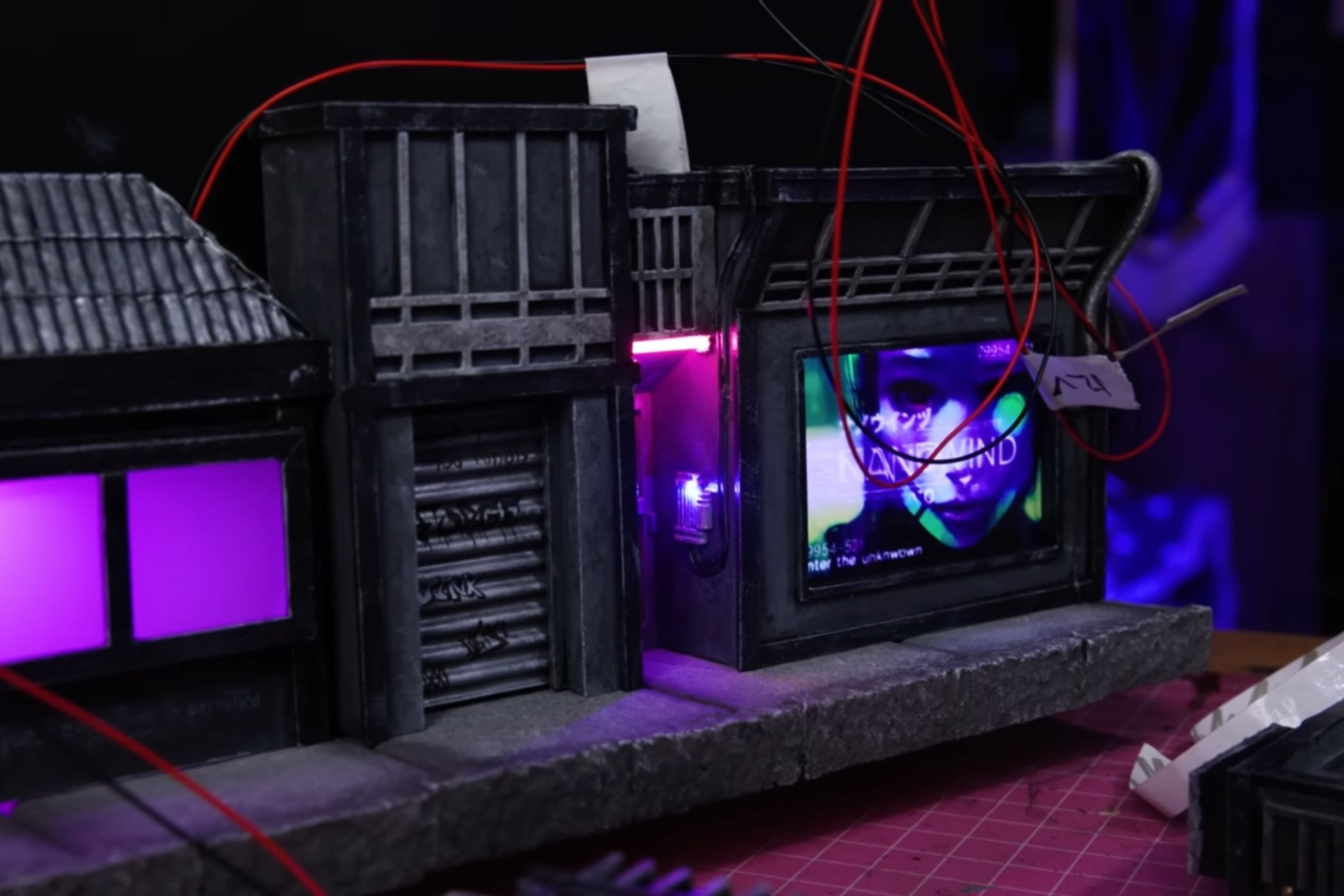 An image showing a wires hanging next to some cardboard art pieces