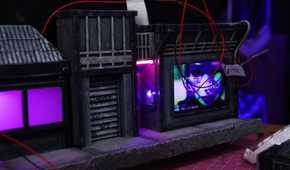 An image showing a wires hanging next to some cardboard art pieces