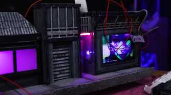 An image showing a wires hanging next to some cardboard art pieces