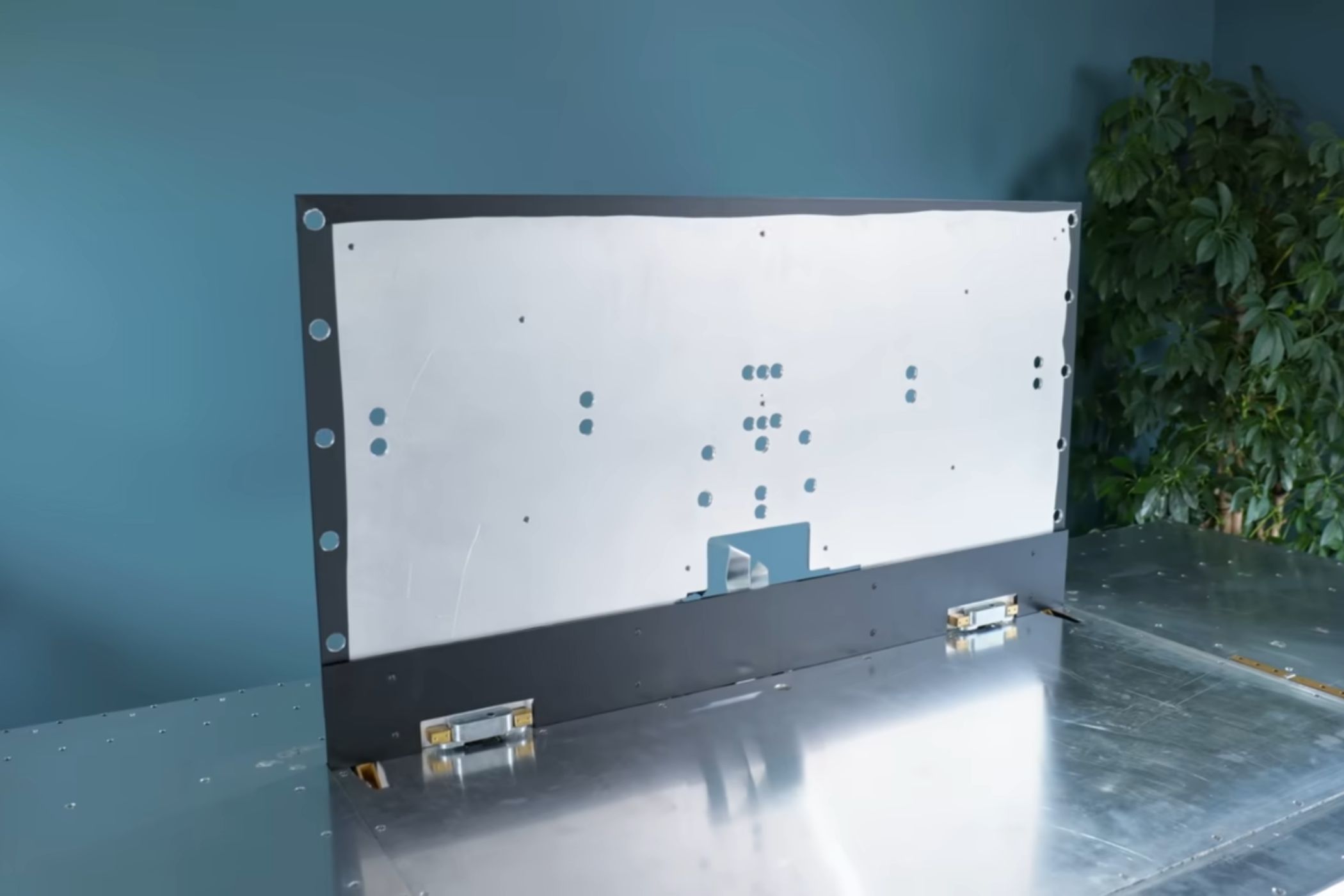 An image showing an aluminum piece cut out standing on another aluminum sheet