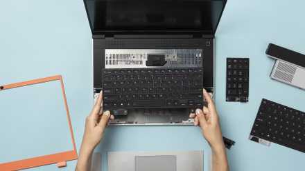 A frame laptop with a keyboard and parts that extend around it