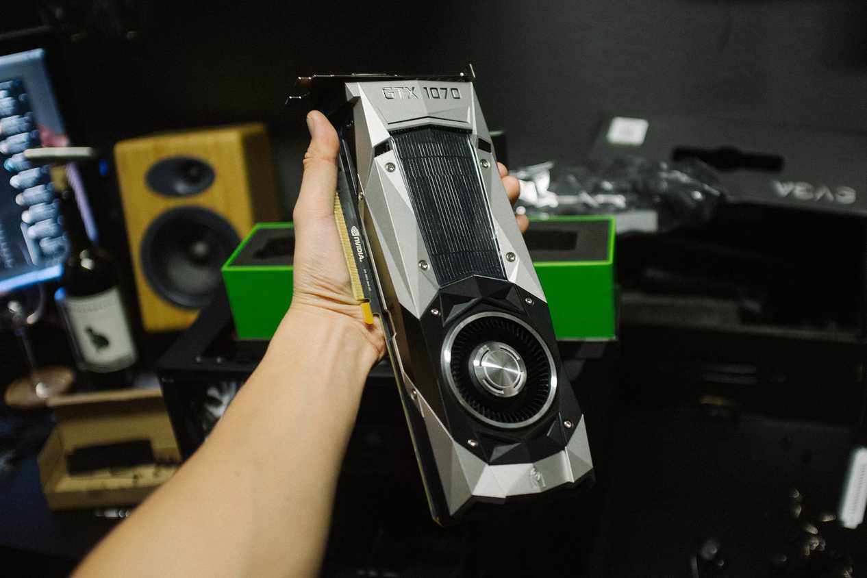 Person holding a GTX 1070 founder's edition graphics card