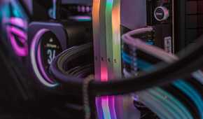 Inside of a gaming PC showing white-themed RAM, CPU cooler, and cables