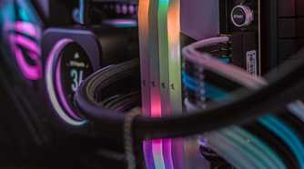 Inside of a gaming PC showing white-themed RAM, CPU cooler, and cables