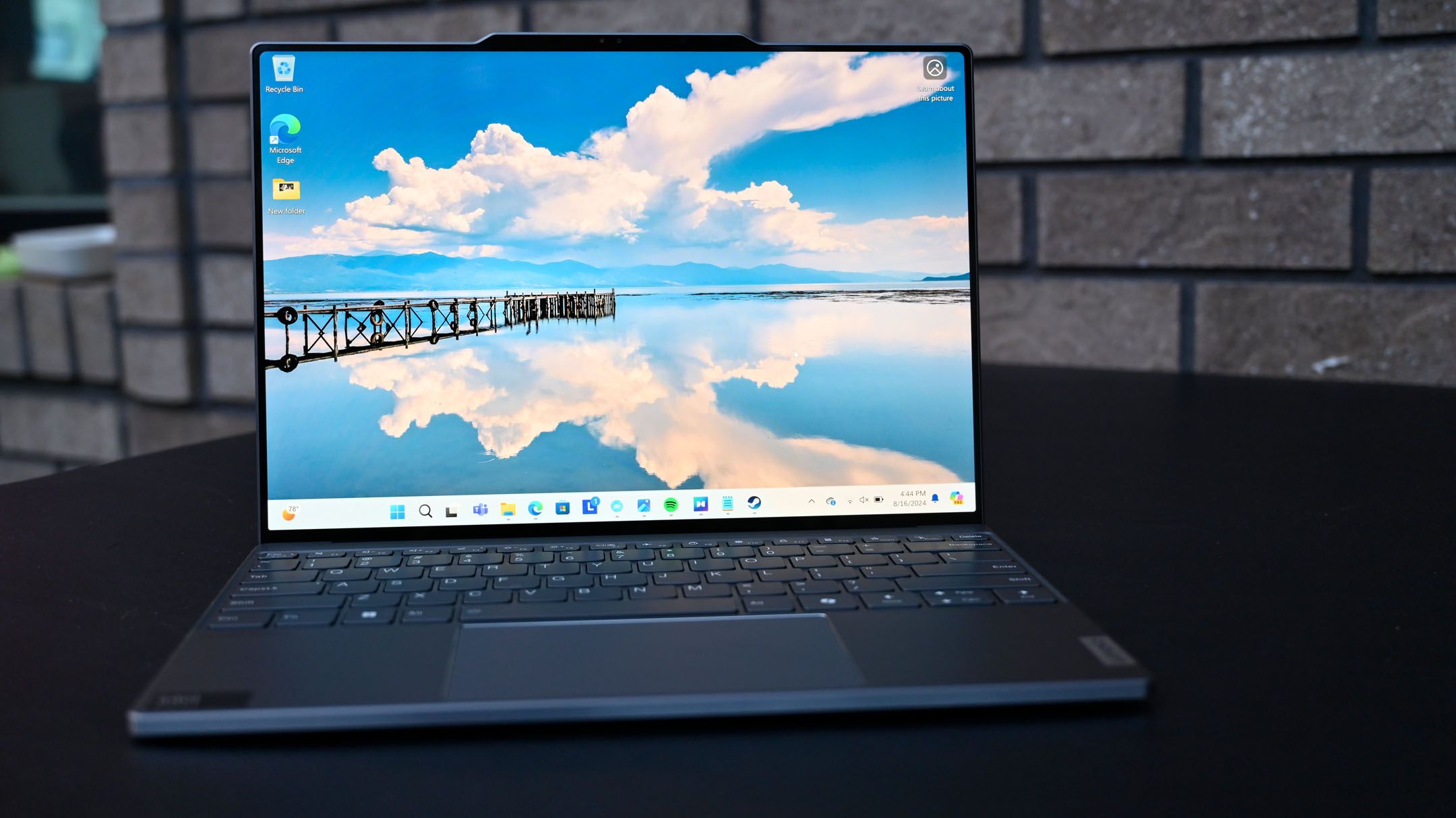 An image of a Lenovo ThinkBook 13x G4 open on black tabletop