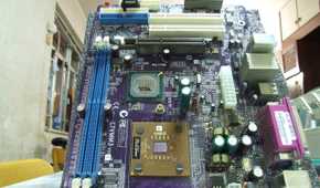 An ATX motherboard lying vertically on a white surface