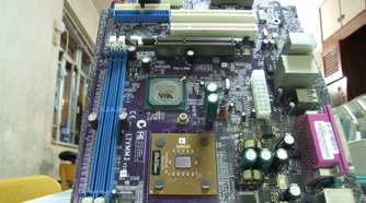 An ATX motherboard lying vertically on a white surface