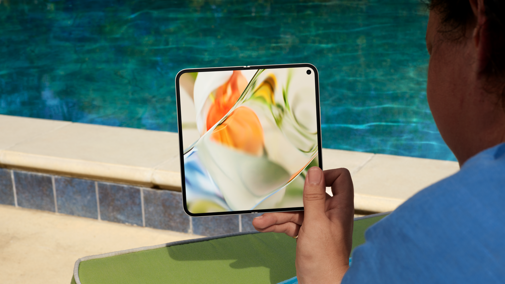 A person holding an unfolded Google Pixel 9 Pro Fold showing the screen 
