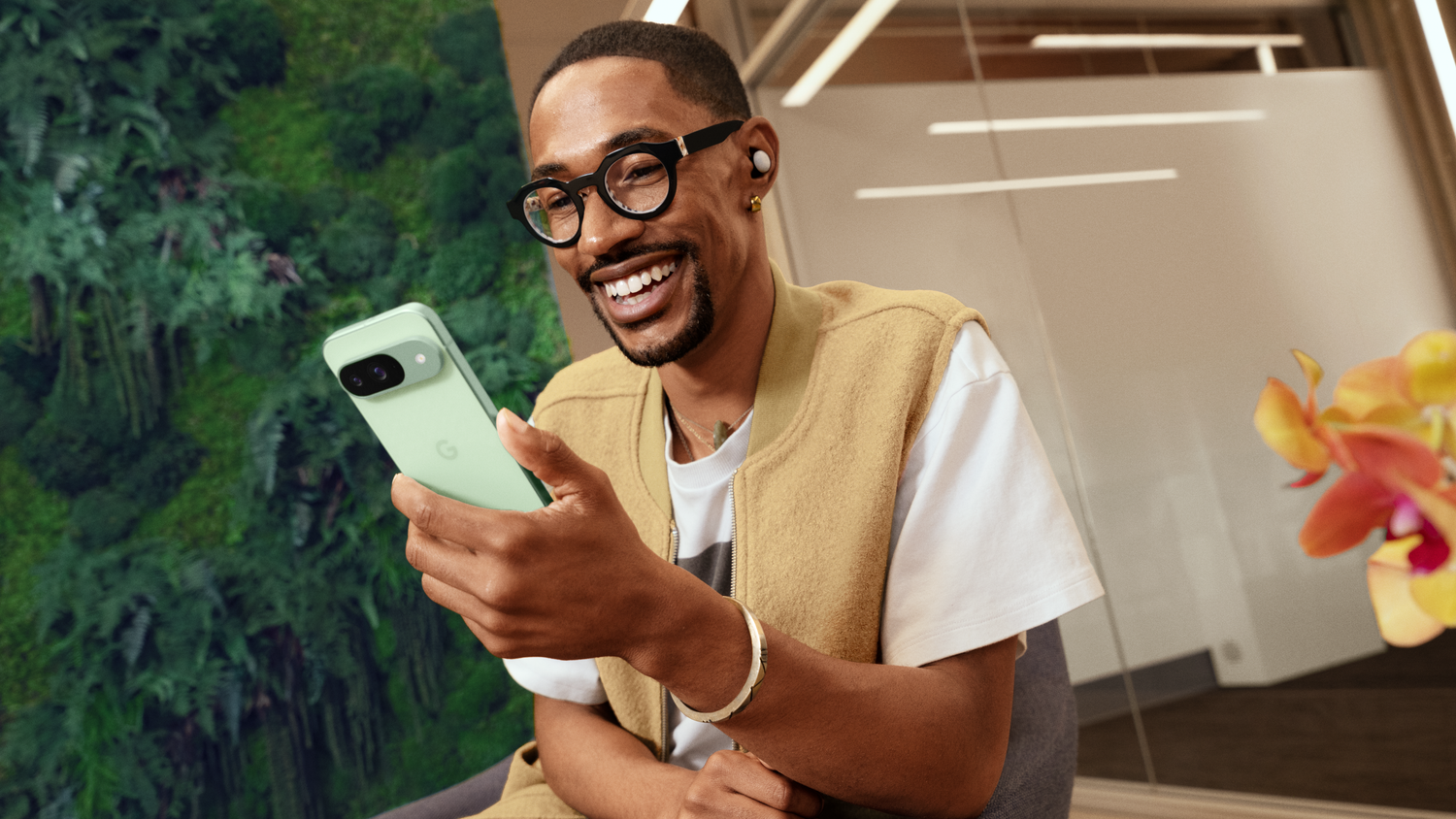 A man holding a Google Pixel 9 in Wintergreen