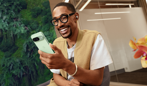 A man holding a Google Pixel 9 in Wintergreen