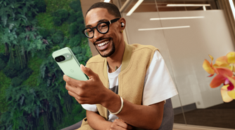 A man holding a Google Pixel 9 in Wintergreen