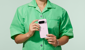 Woman holding a Rose Quartz Google Pixel 9 Pro in both hands showing the back of the phone