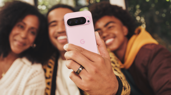 A man taking a group selfie using a Google Pixel 9 Pro in Rose Quartz