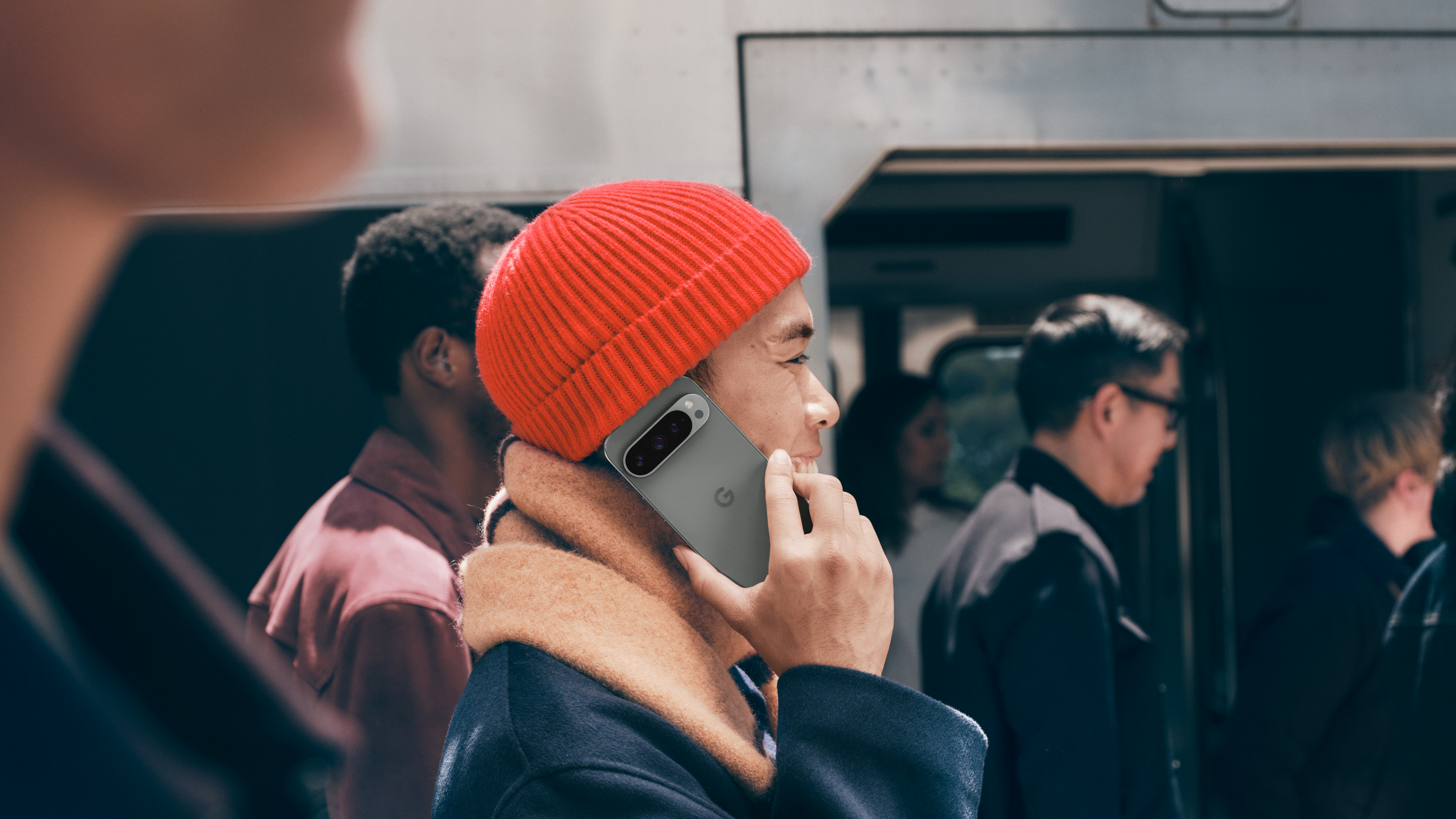 A man holding Google Pixel 9 Pro up to his ear as if making a call