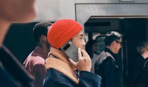 A man holding Google Pixel 9 Pro up to his ear as if making a call