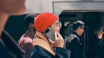 A man holding Google Pixel 9 Pro up to his ear as if making a call