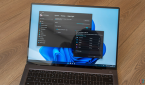 A Windows 11 laptop displaying the settings for night light and OneDrive backups