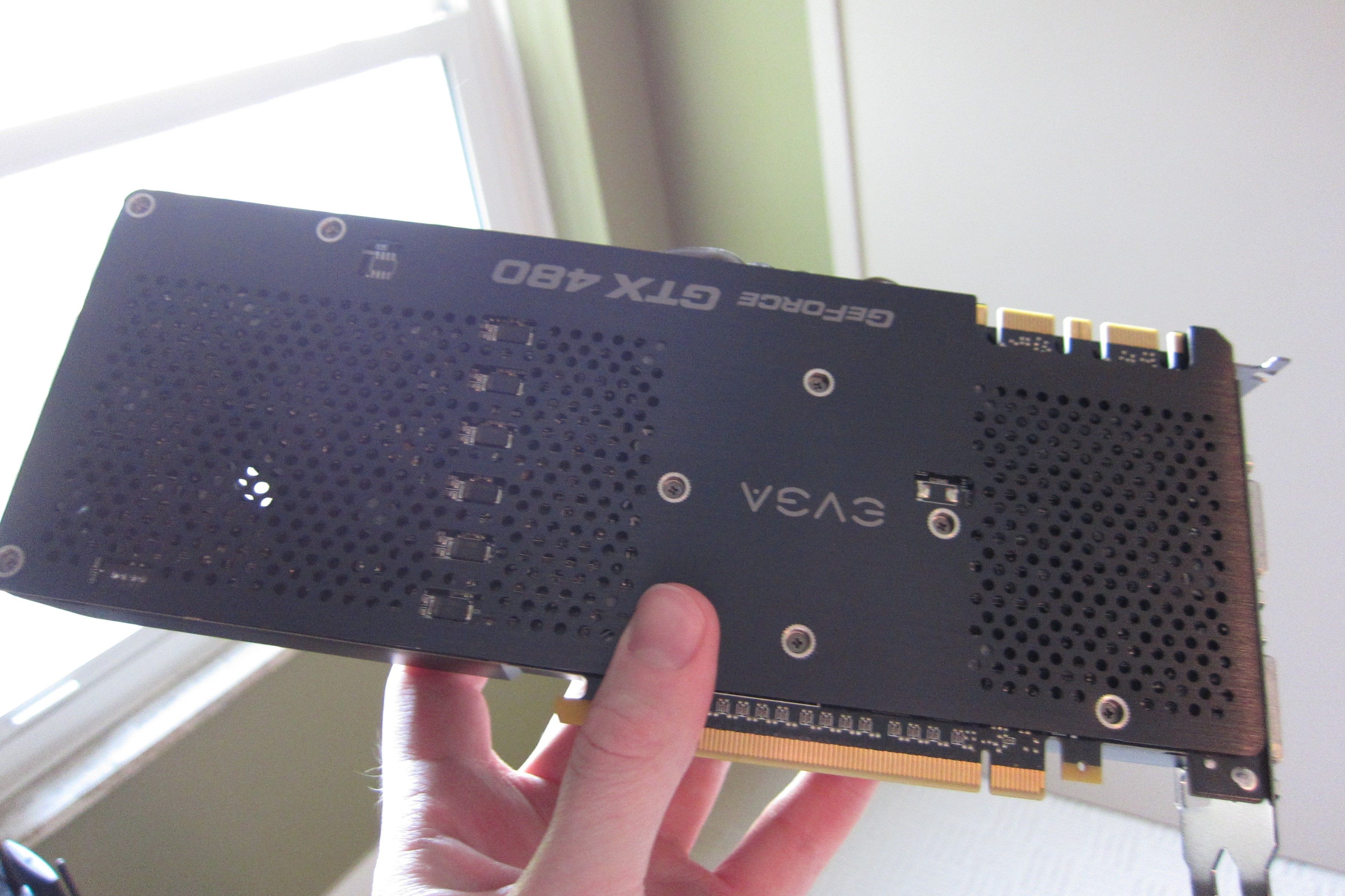 An old Nvidia graphics card in a person's hand