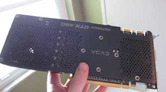 An old Nvidia graphics card in a person's hand
