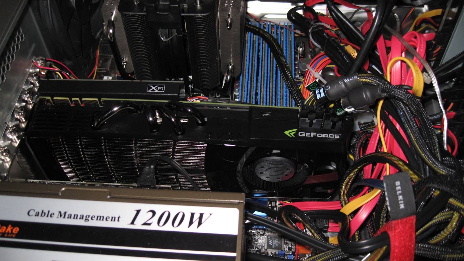 Inside of a gaming PC showing an Nvidia graphics card, power supply, and CPU cooler