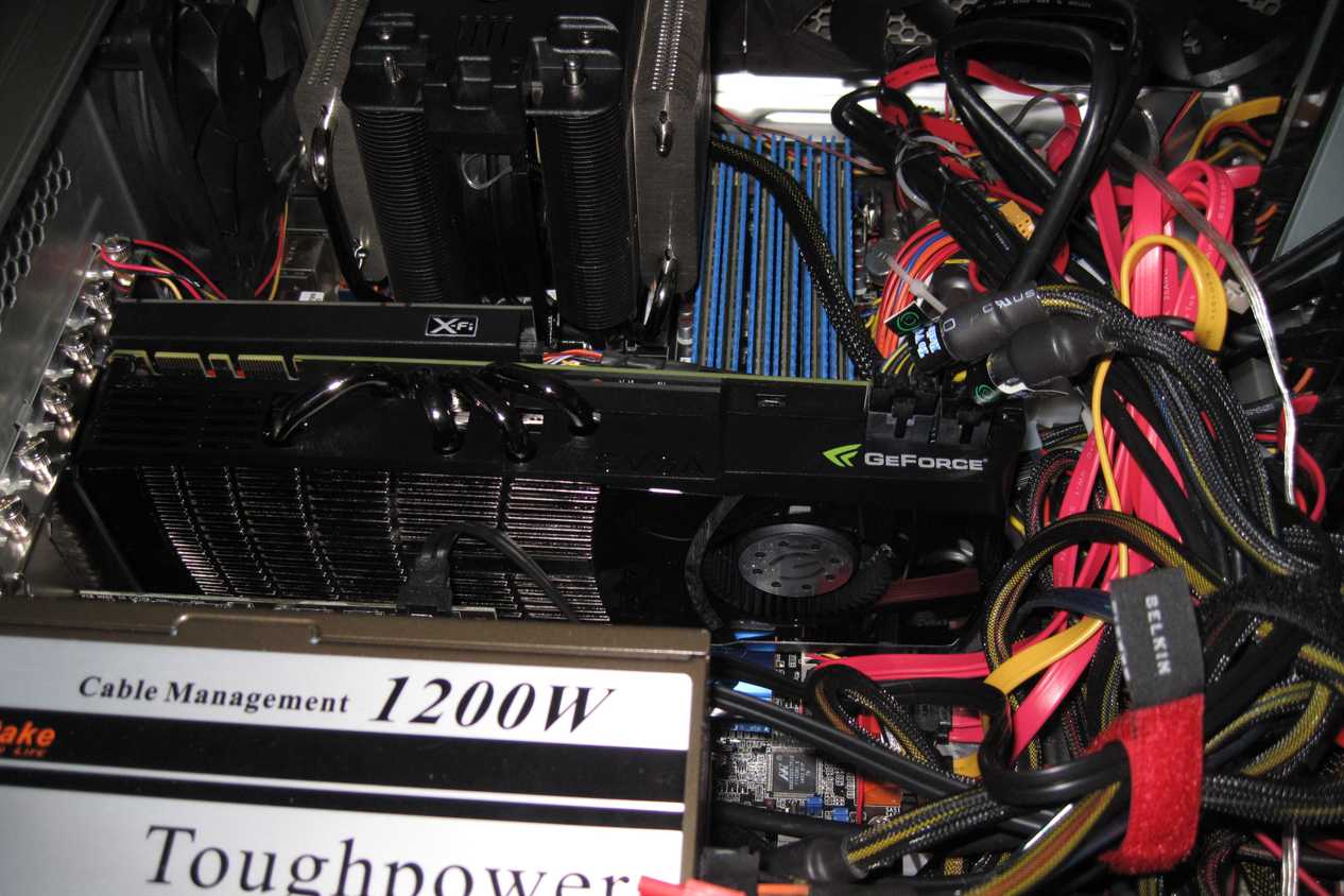 Inside of a gaming PC showing an Nvidia graphics card, power supply, and CPU cooler