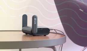 small wifi router on a table with representation of wireless data flowing through the air