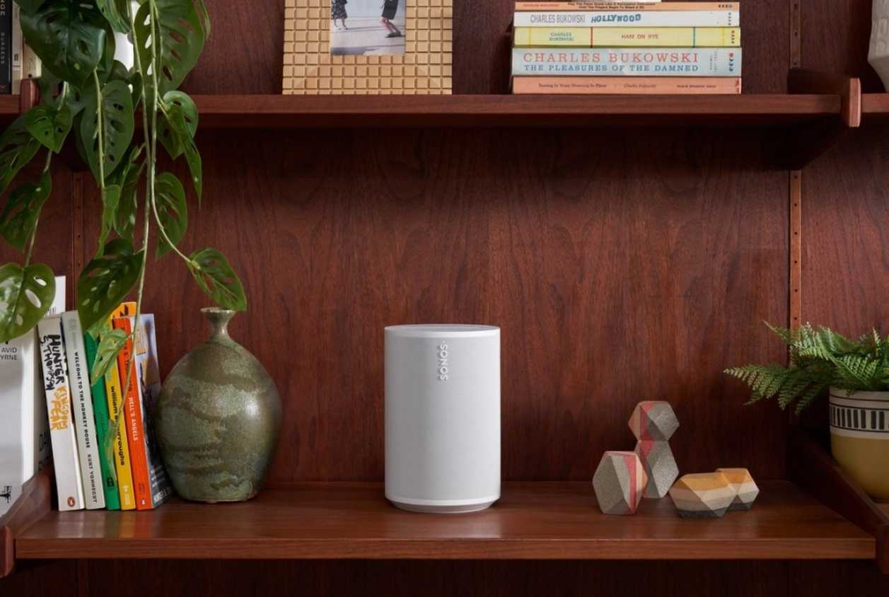 sonos era 100 speaker in white on a bookshelf