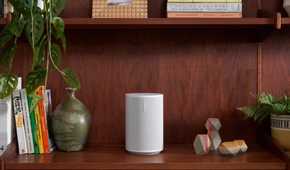 sonos era 100 speaker in white on a bookshelf