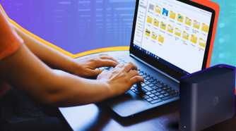 Synology Beestation NAS along with a person using a Windows laptop with the file explorer open