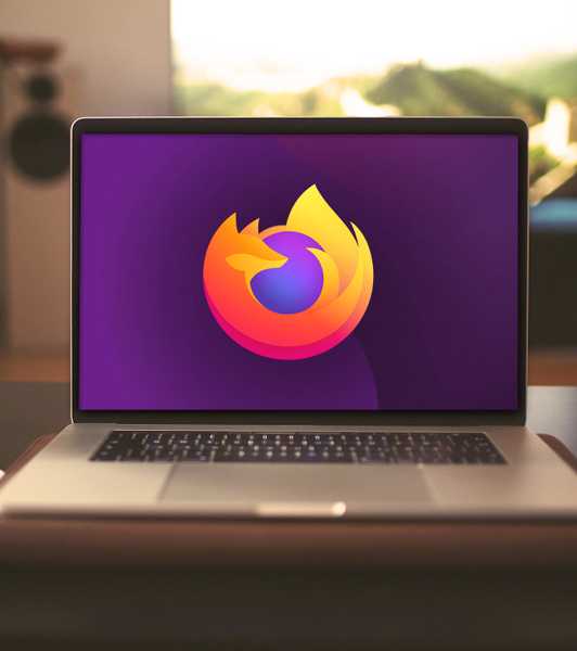 A MacBook Pro laptop with a Mozilla Firefox logo on the screen
