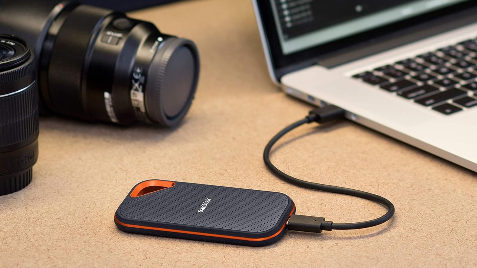 SanDisk 2TB Extreme PRO Portable SSD next to laptop and camera