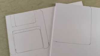Outlines of floppy disk stenciled on foam board