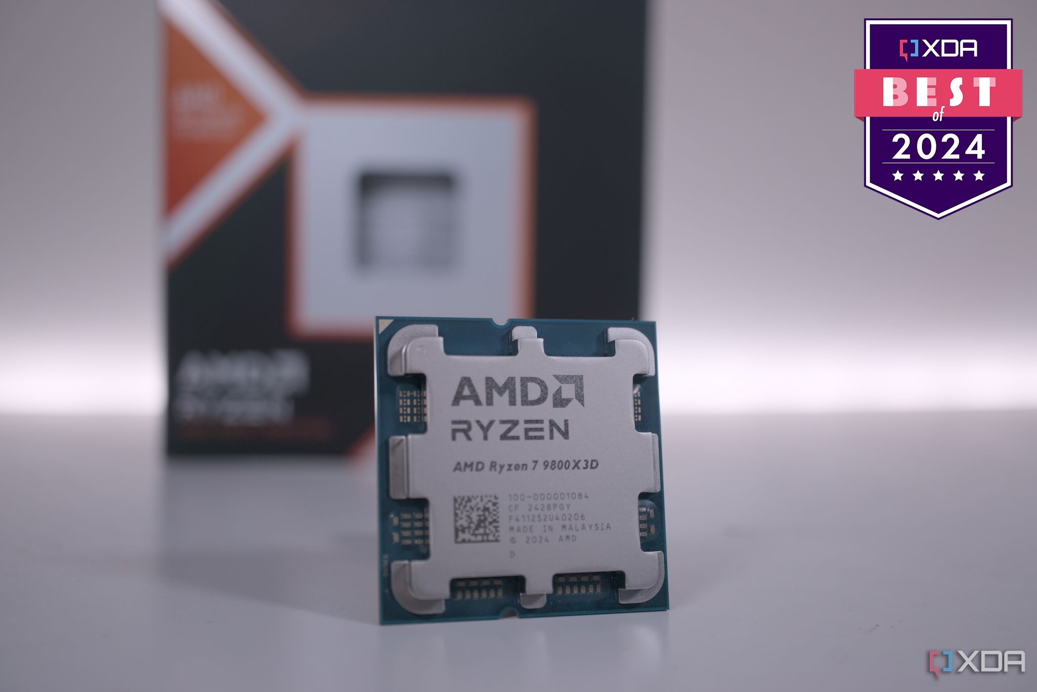 AMD Ryzen 7 9800X3D on a white surface with a badge reading XDA Best of 2024