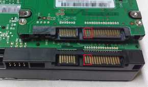 A 2.5-inch hard drive on top of a 3.5-inch hard drive showing SATA power connectors