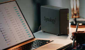 Synology DS124 on desk next to laptop