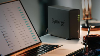 Synology DS124 on desk next to laptop