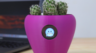 A purple flower pot with a freezing emoji on it