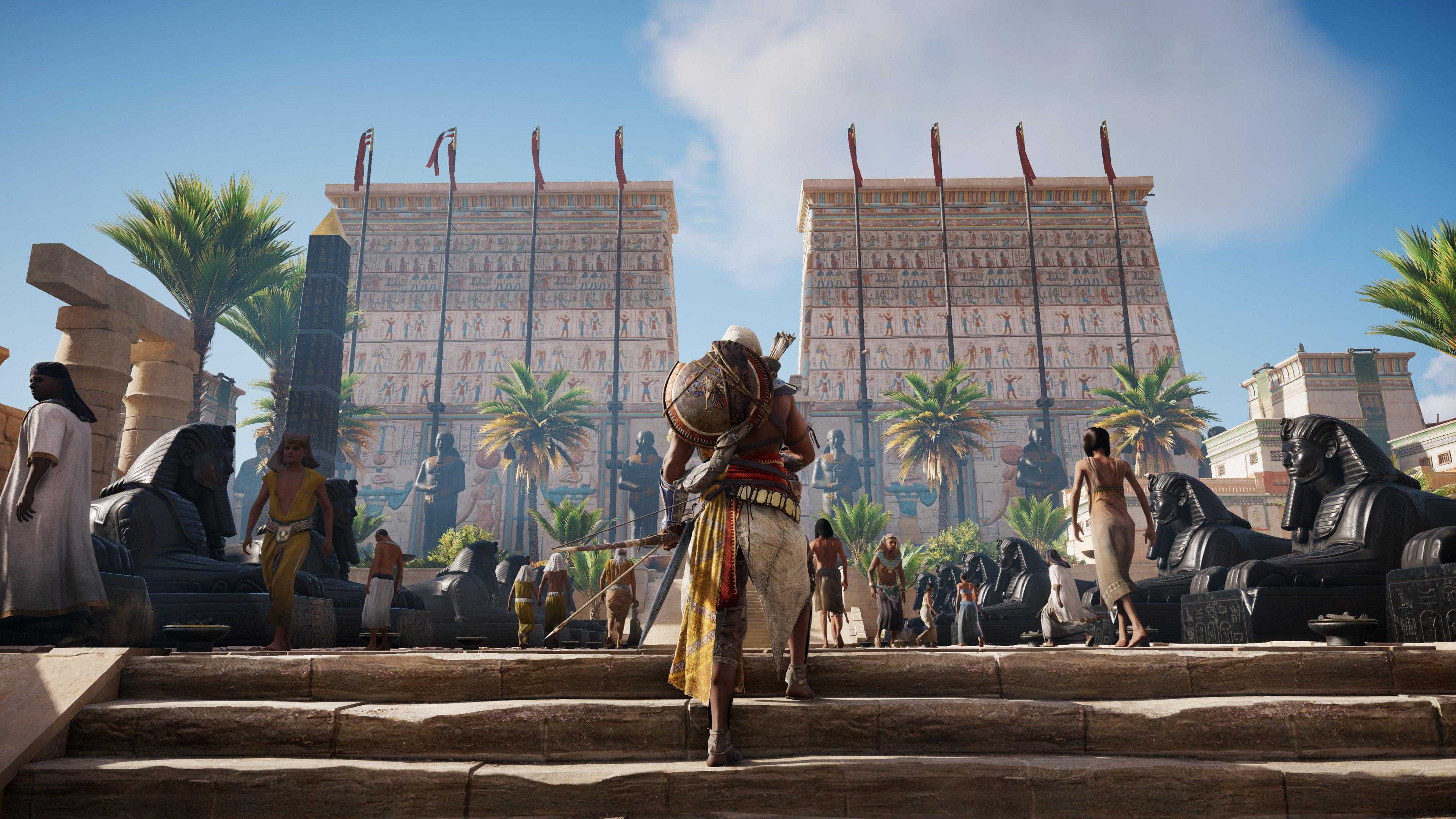 Bayek walking up stairs to an Ancient Egyptian temple