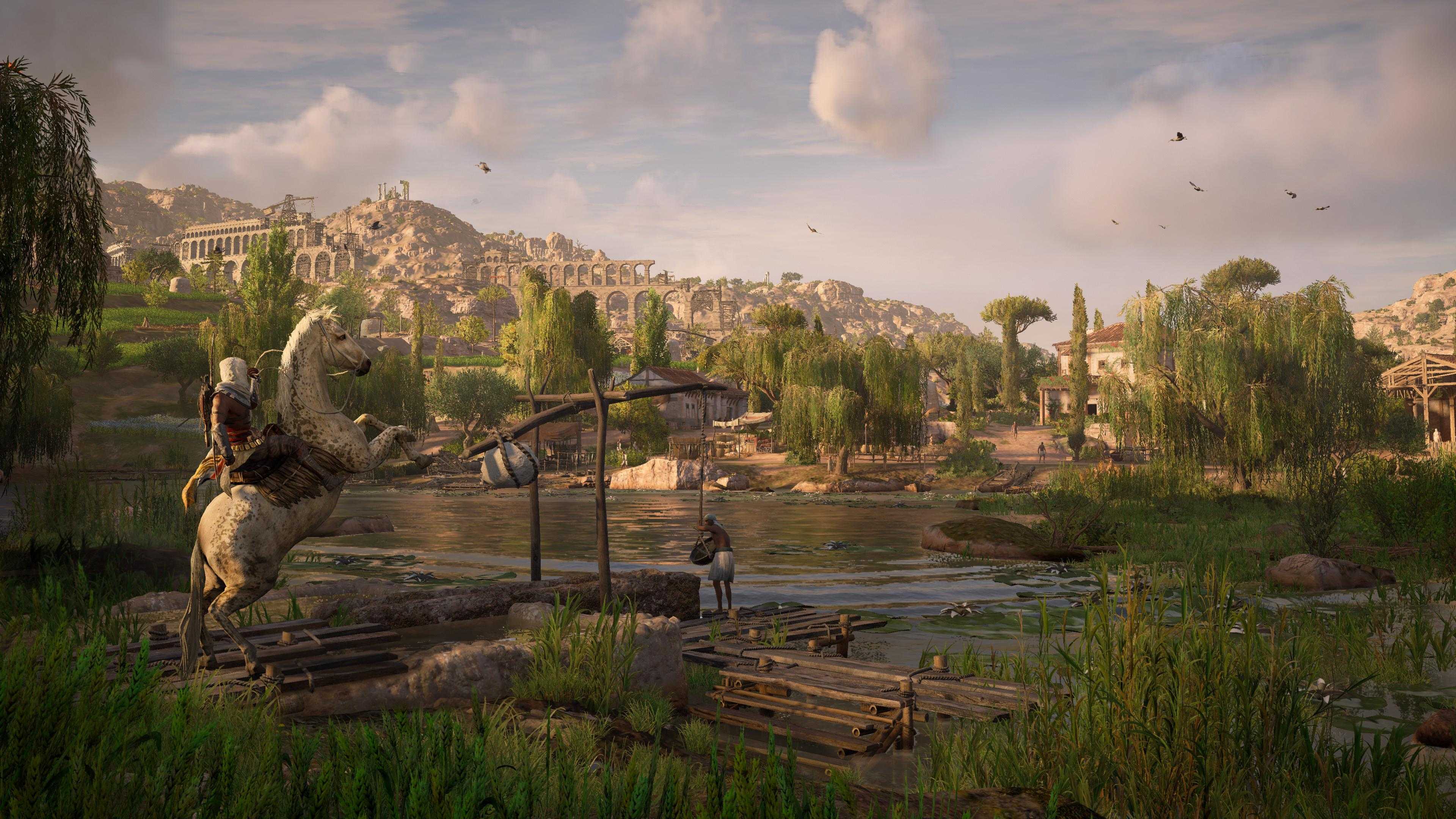 Bayek on horseback looking at the nile in a green area