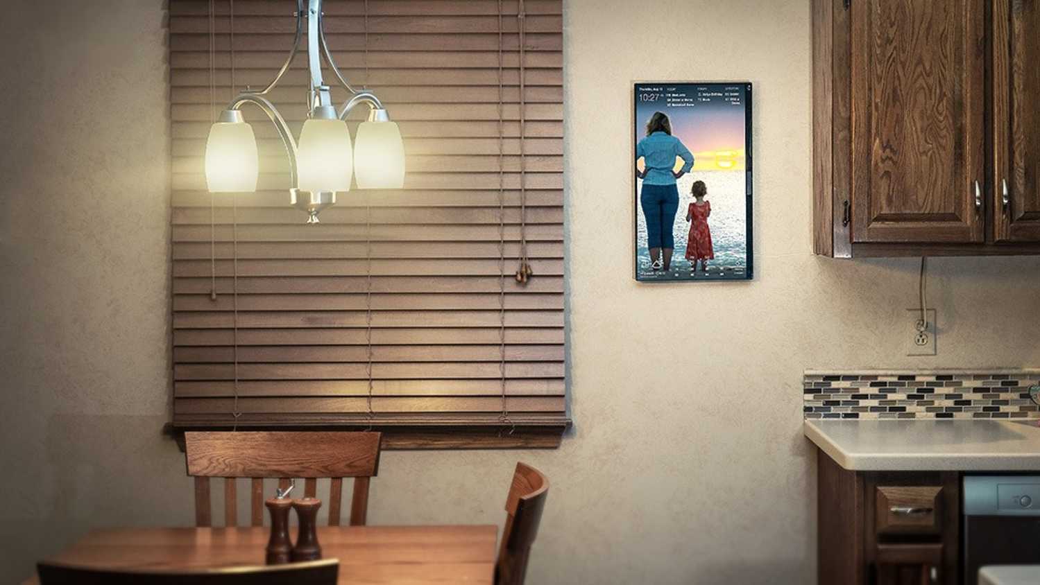 dakboard smart display mounted on a kitchen wall