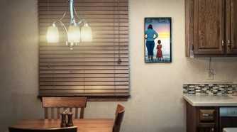 dakboard smart display mounted on a kitchen wall
