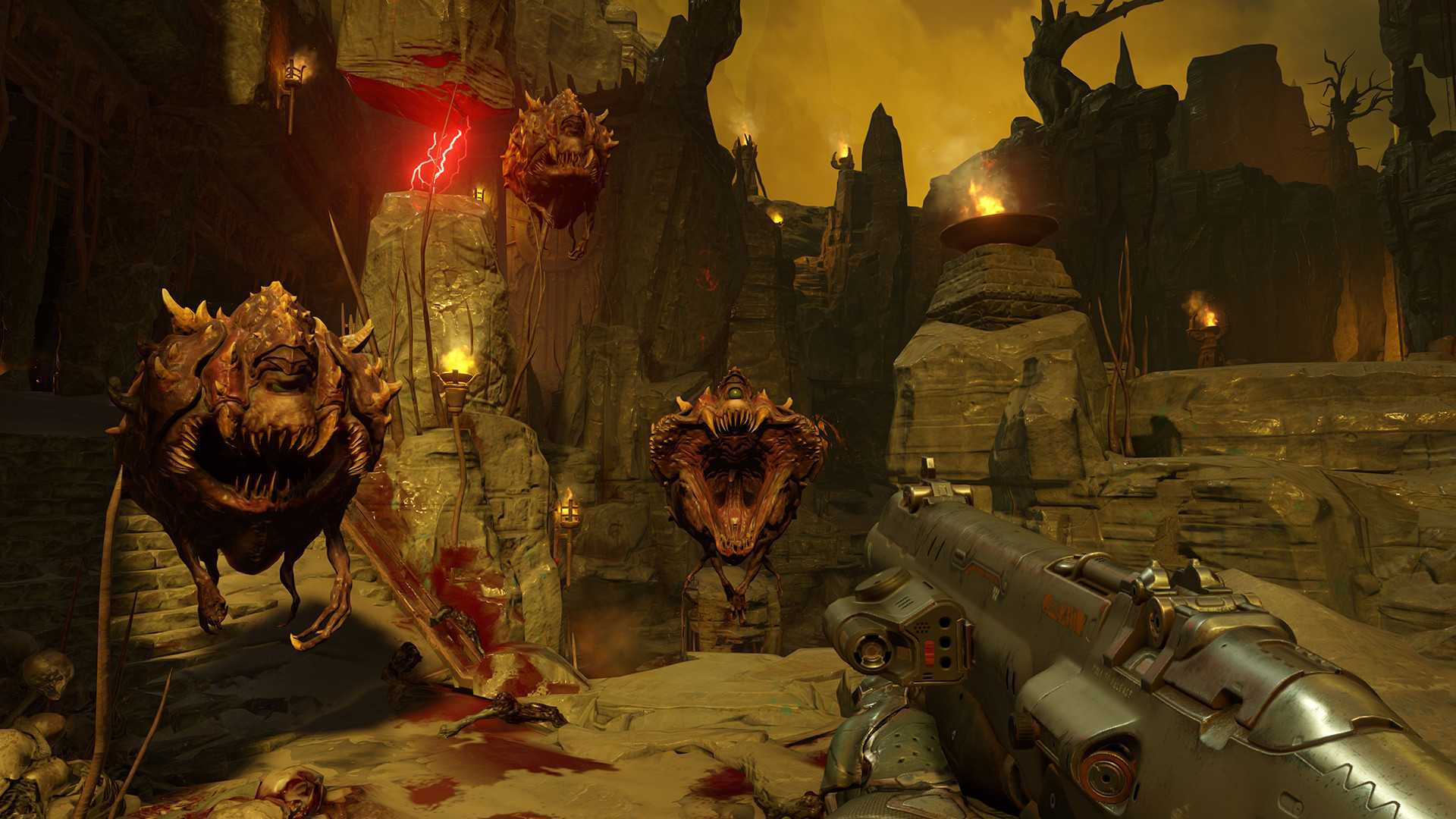 Screenshot from DOOM (2016) video game with three floating demon enemies pursuing player character in hellish environment