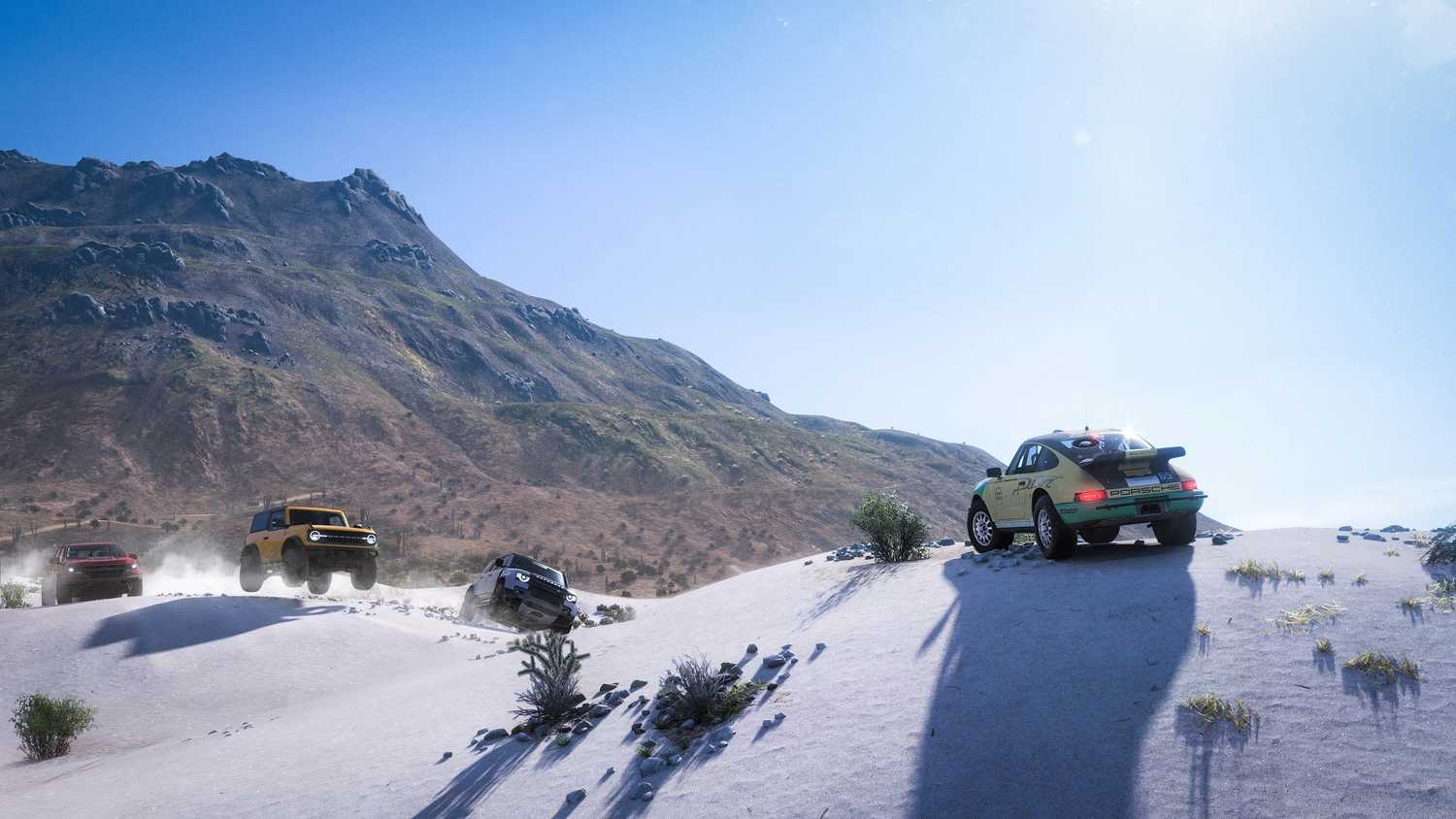 Screenshot from Forza Horizon 5 video game of cars parked at the top of a snowy mountain